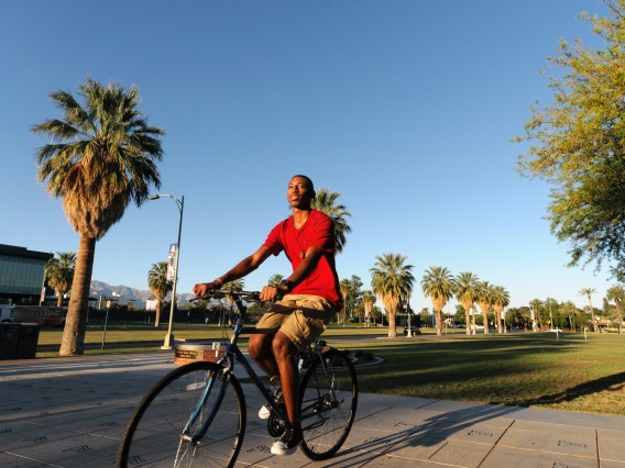 student cycling along the Mall