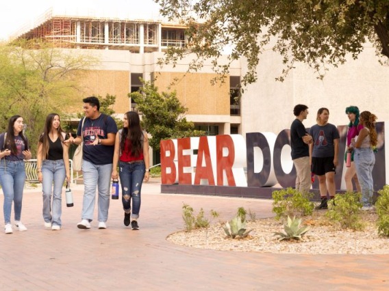 A group of students walks past the BEARDOWN sign in the Student Success District.