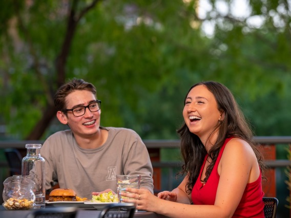 Students enjoying a meal on a restaurant patio