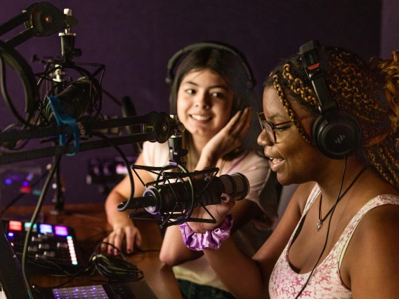 Two students in a radio or recording lab