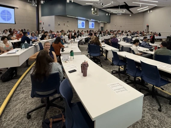 A large classroom is full with attendees at the Conflict Resolution and De-escalation Skills Symposium