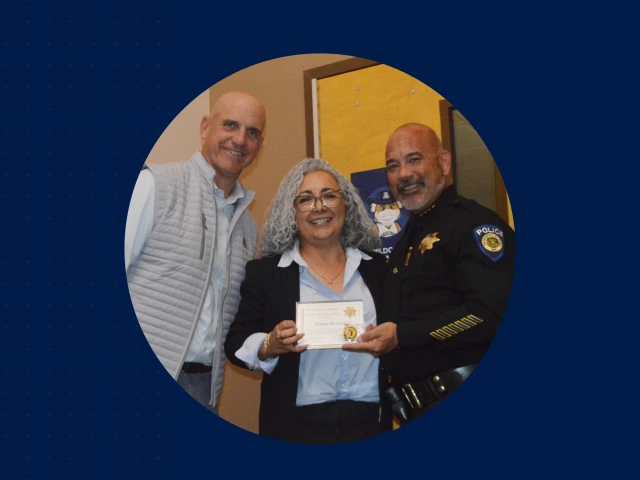 Steve Patterson and Chief Olson pose with UAPD Community Academy graduate Karina McCune
