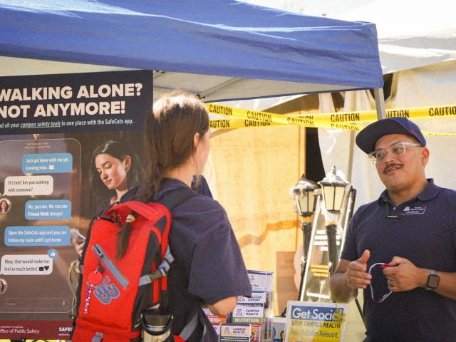 Campus Health representative speaks with a student at the 2025 Wildcat Safety Fair.